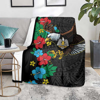 Folded black throw blanket draped with eagle and hibiscus floral African pattern