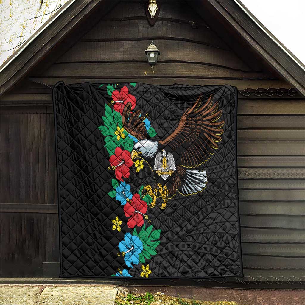 Black quilt hanging outdoors with colorful hibiscus floral and eagle emblem