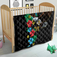 Black quilt on baby bed featuring colorful hibiscus flowers and eagle wings