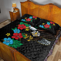 Black quilt bed set with hibiscus floral pattern and eagle graphic on bed with pillows