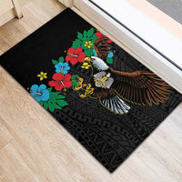 Black rubber doormat with hibiscus flowers and spread-wing bird on geometric pattern background