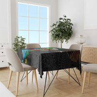 Black tablecloth with colorful hibiscus flowers and geometric motifs across table