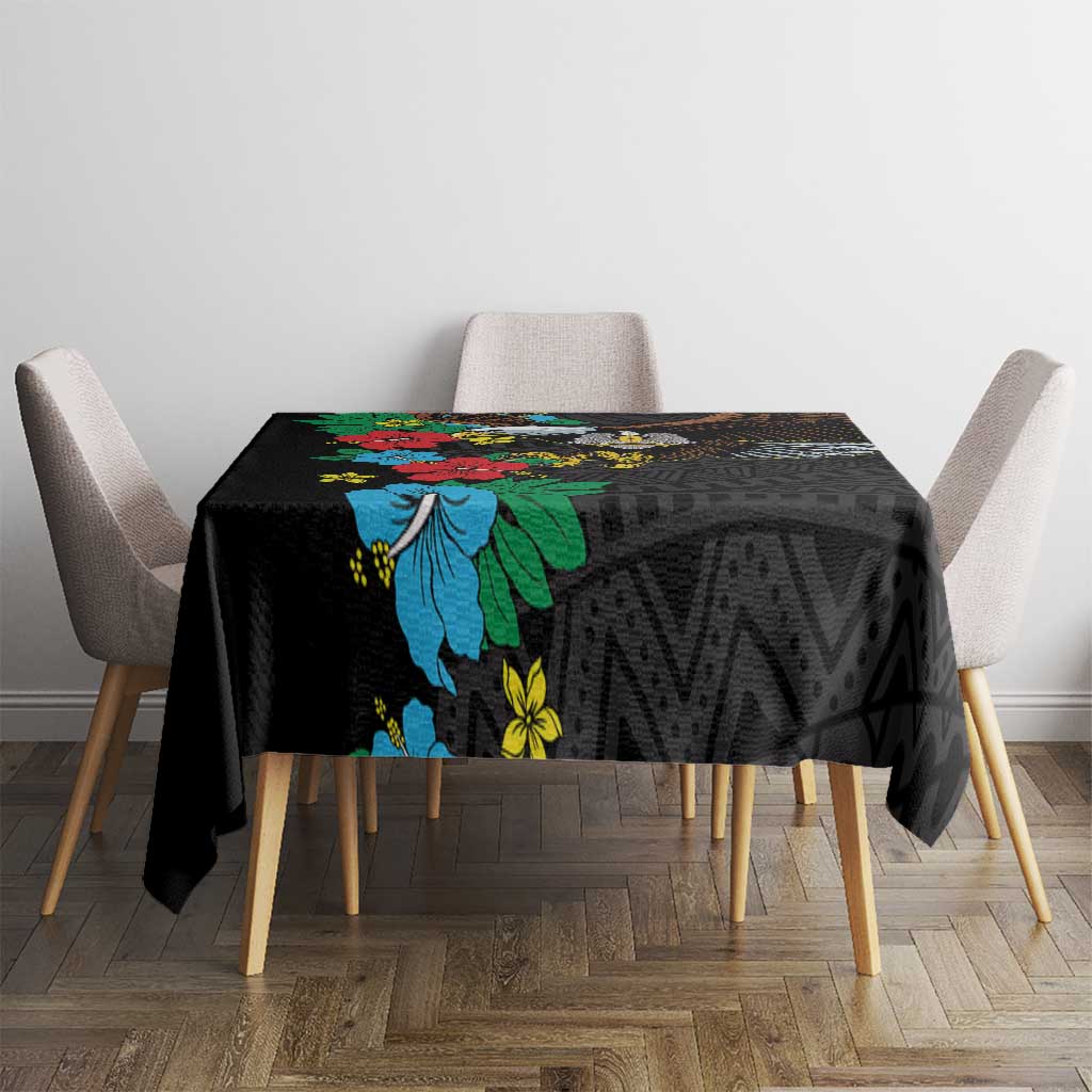 Black tablecloth with bold blue hibiscus flowers and geometric texture pattern
