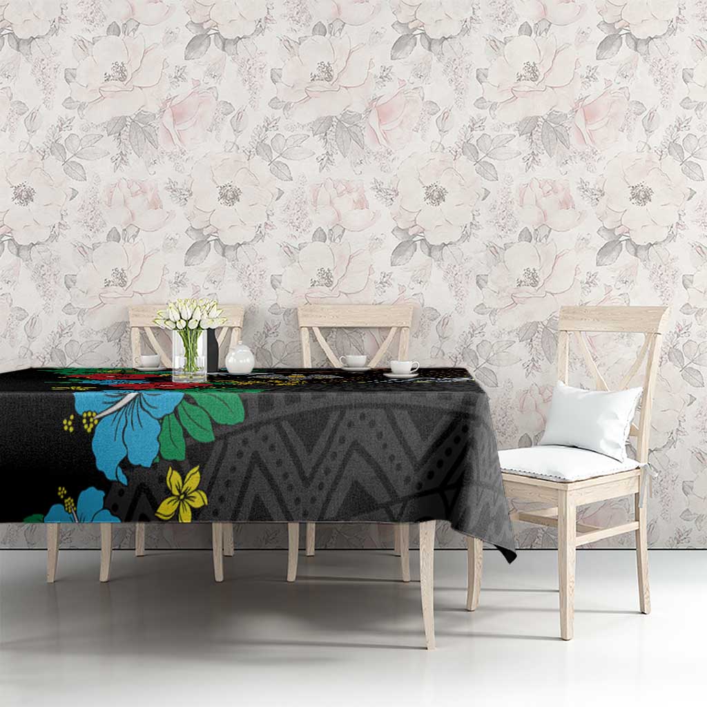Black tablecloth with hibiscus and botanical accents over dark geometric pattern