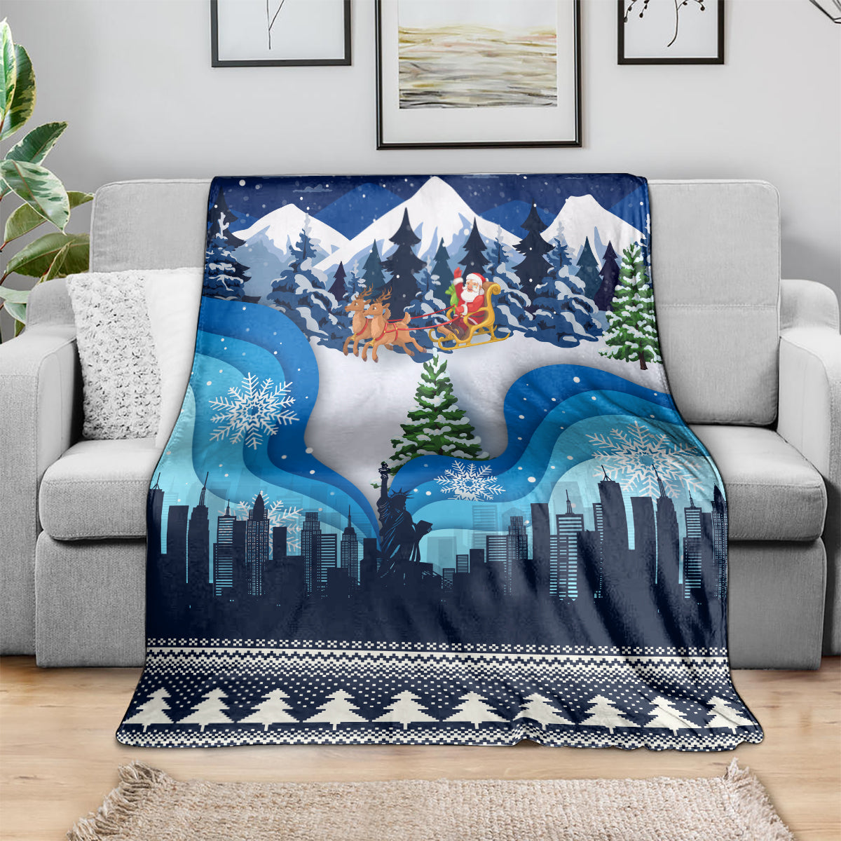 Blue winter-themed Christmas throw blanket with skyline, pine forest, and geometric border.