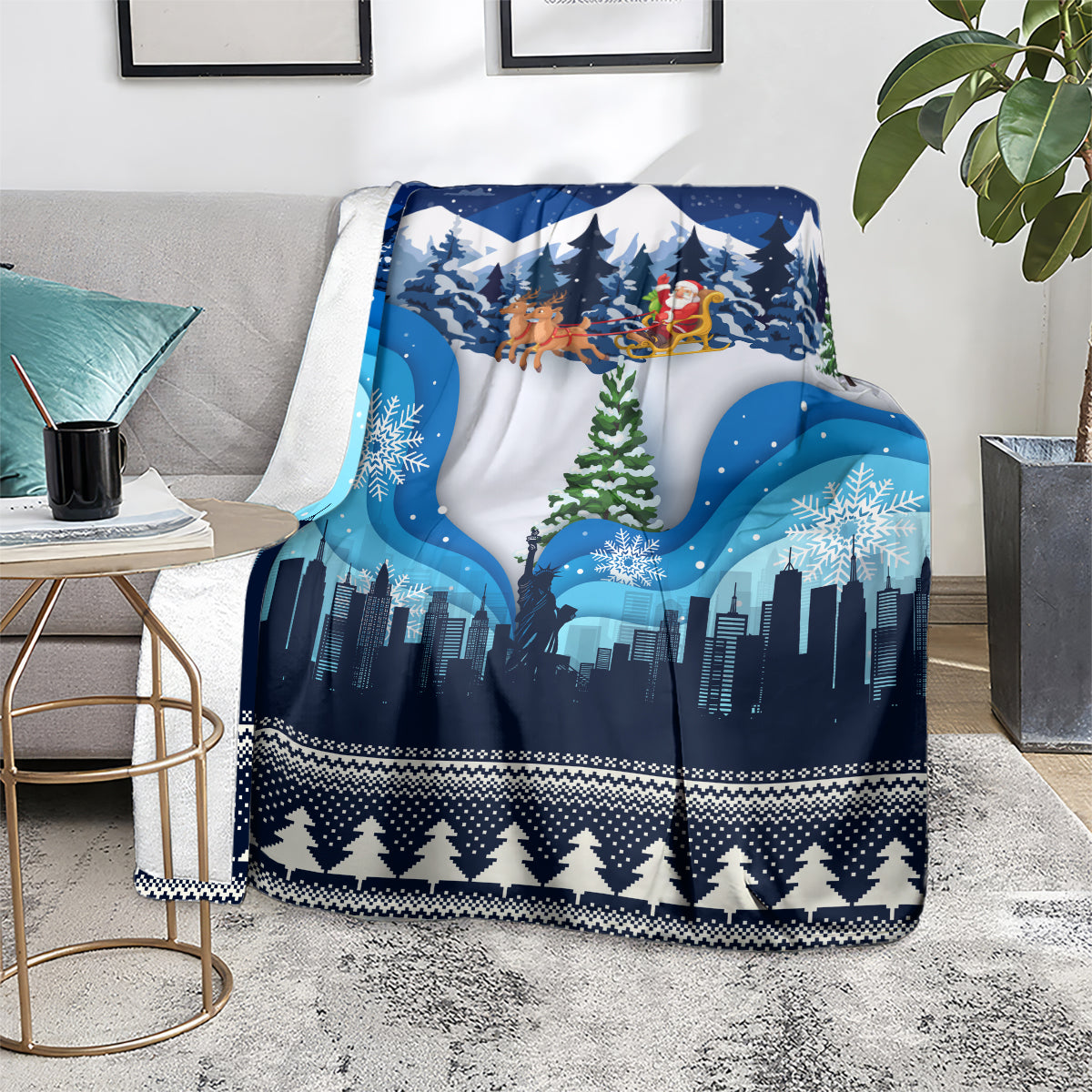 Blue Christmas blanket on living room sofa, showing skyline, reindeer sleigh, and pine trees.