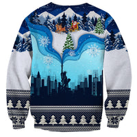 Blue unisex crewneck sweatshirt with snowy skyline, Liberty statue, and festive border cuffs