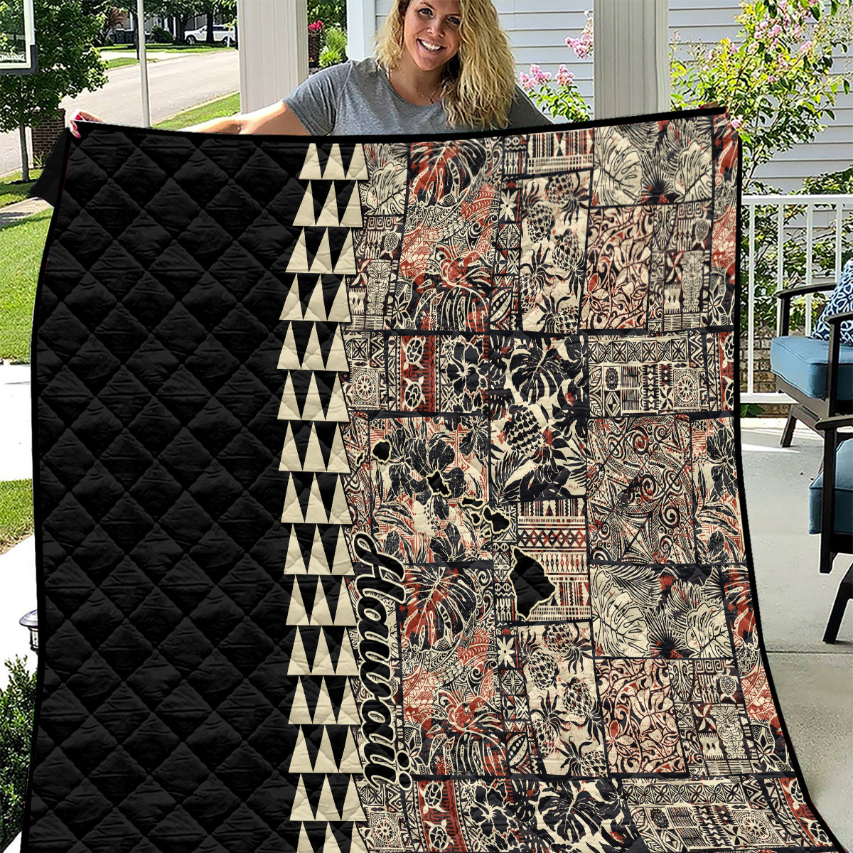 Quilt with black diamond quilted panel and beige patchwork with colorful tiki-style motifs