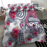 Tropical floral paisley comforter and pillowcases, white base with magenta blooms and navy motifs.