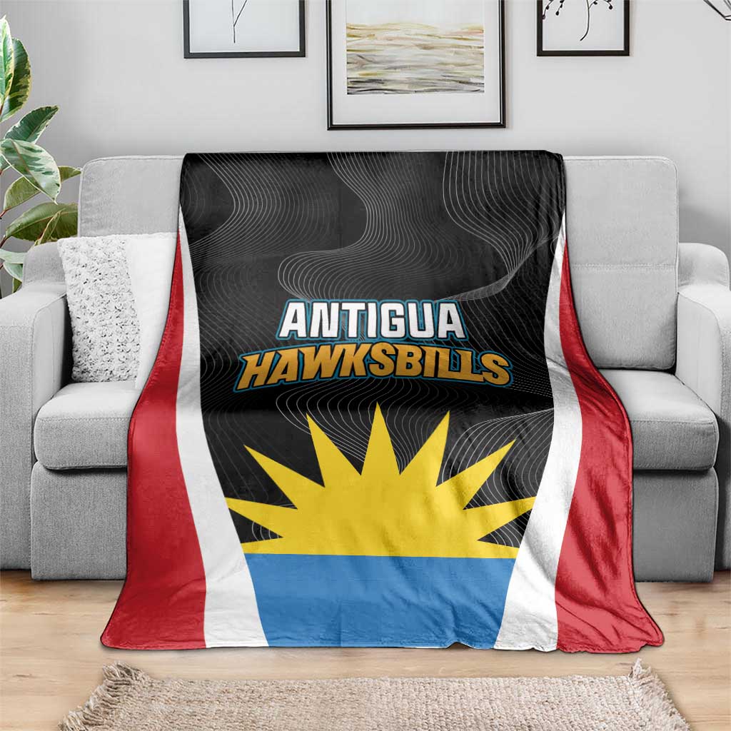 Antigua Cricket Hawksbills blanket draped on a sofa, black top with team text
