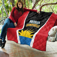 Red quilt with Antigua Hawksbills logo, black textured center, and blue/yellow sun emblem