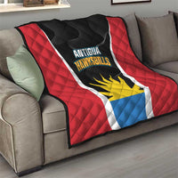 Red, black, and white Antigua Hawksbills quilt with sun emblem draped on a sofa