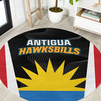 Round black rug with Antigua Hawksbills logo, yellow sunburst, red/white/blue border