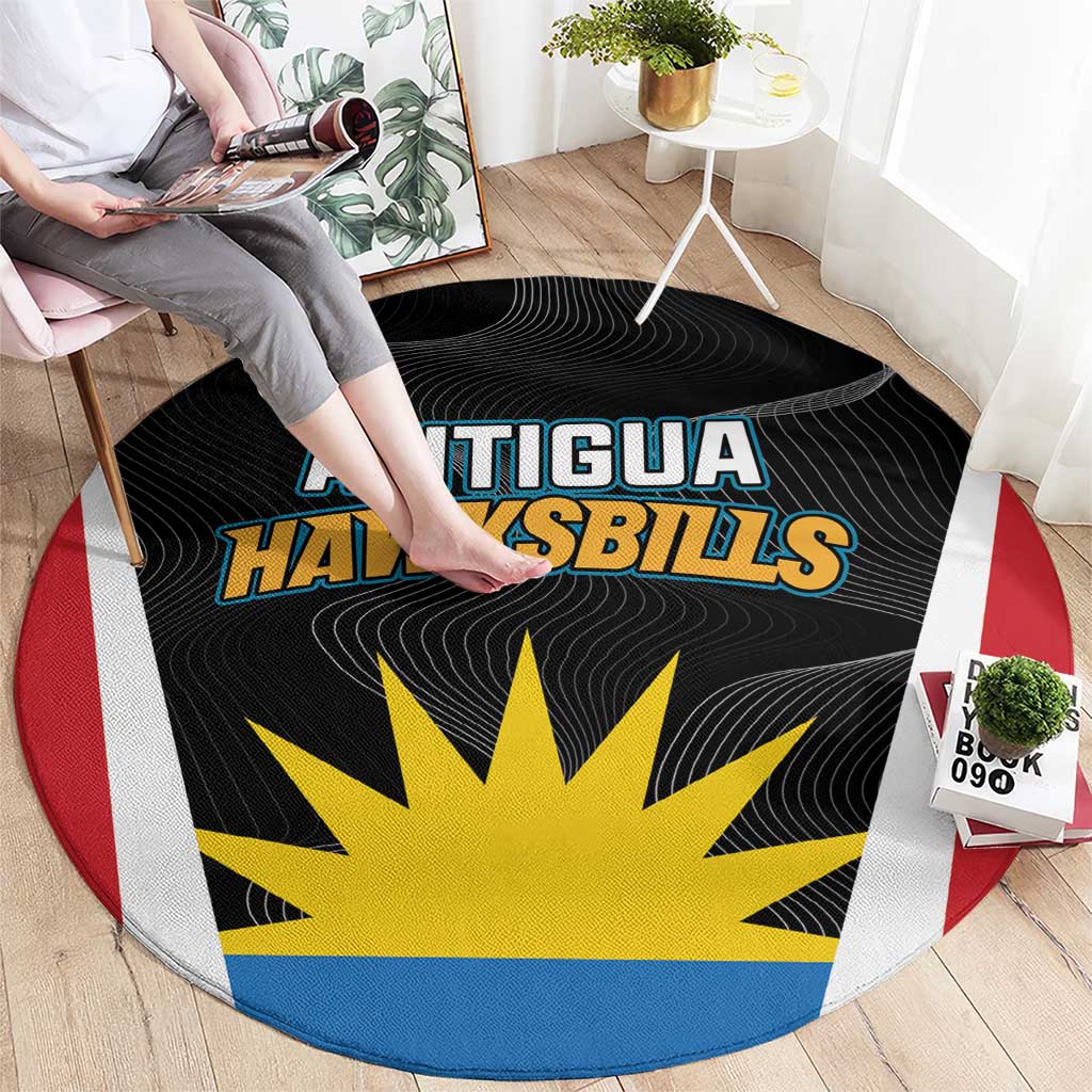 Round black rug with Antigua Hawksbills logo, yellow sunburst, red/white/blue edge