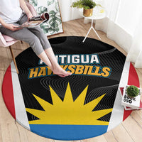 Round black rug with Antigua Hawksbills logo, yellow sunburst, red/white/blue edge