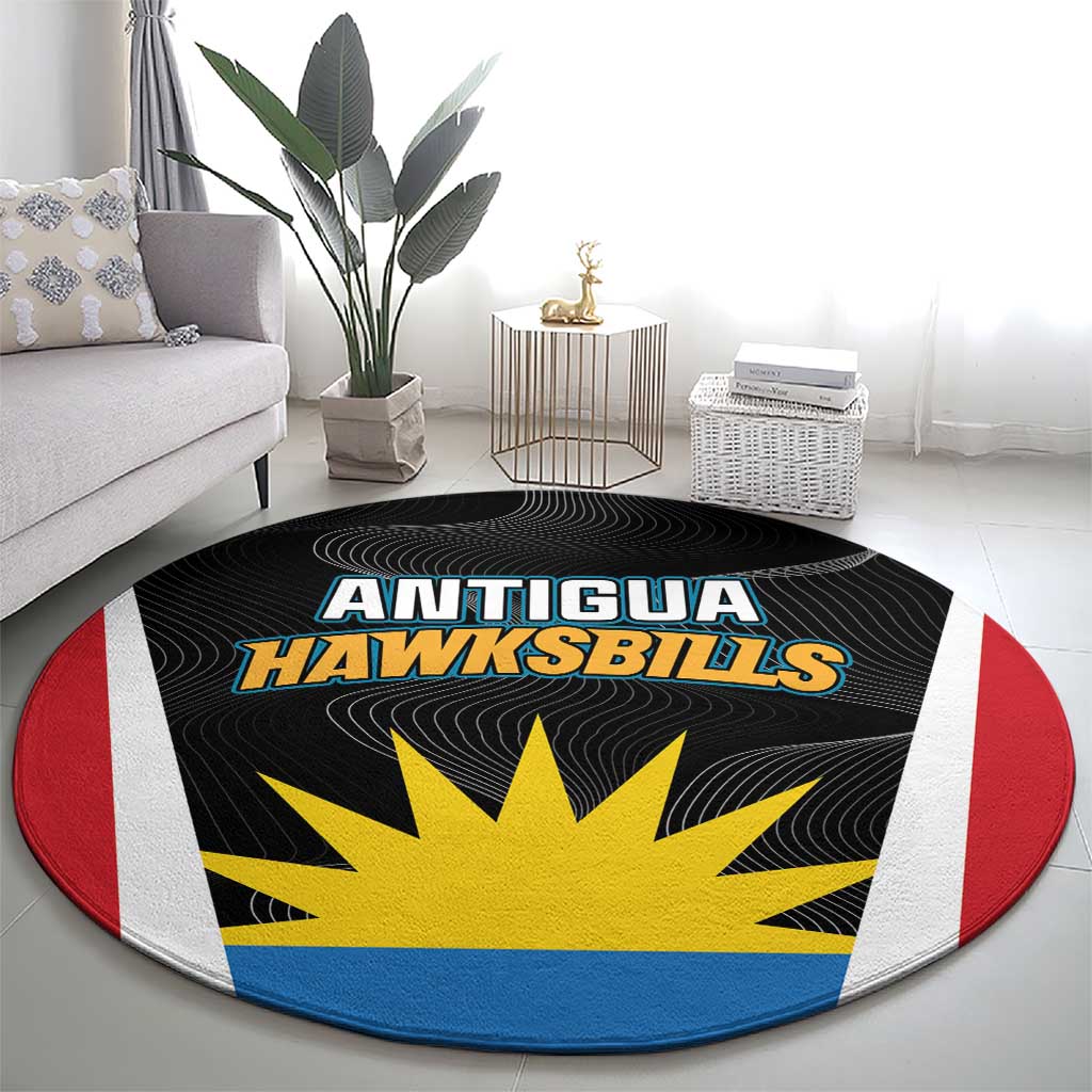 Round black carpet with Antigua Hawksbills text and yellow sunburst, concentric stripes