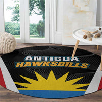 Round black rug with Antigua Hawksbills logo, yellow sunburst, blue outer band