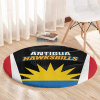 Round black rug with Antigua Hawksbills logo and yellow sunburst, curved red side