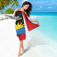 Antigua Hawksbills sarong tied at neck, black/red/blue/white flag print with yellow emblem