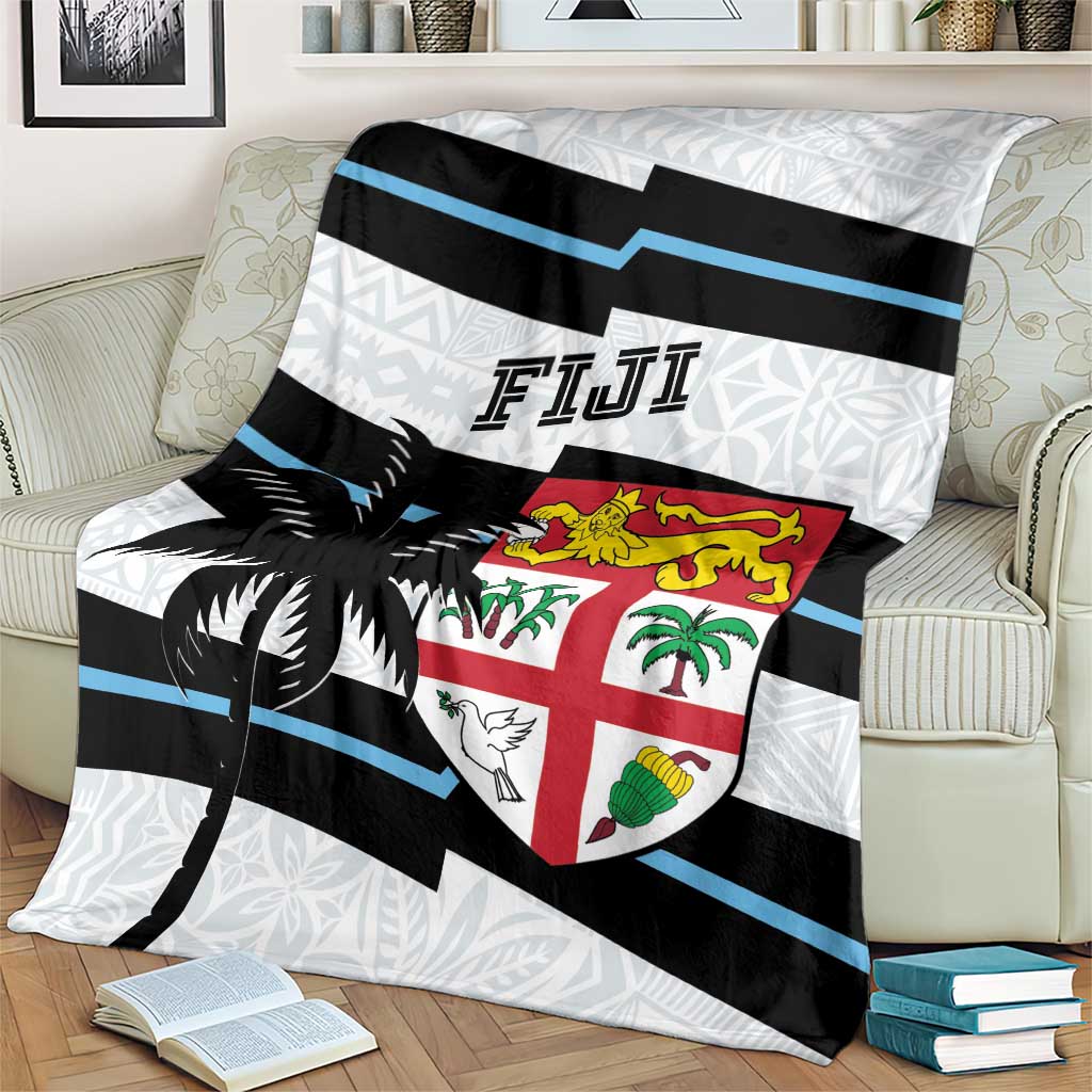 Fiji rugby blanket on armchair with blue striped bands, black palm graphic, and crest