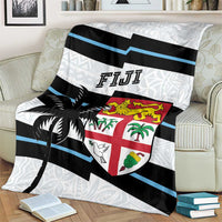 Fiji rugby blanket on armchair with blue striped bands, black palm graphic, and crest
