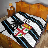 Rugby quilt on bed: white base with black and blue diagonal stripes, palm tree and Fiji crest