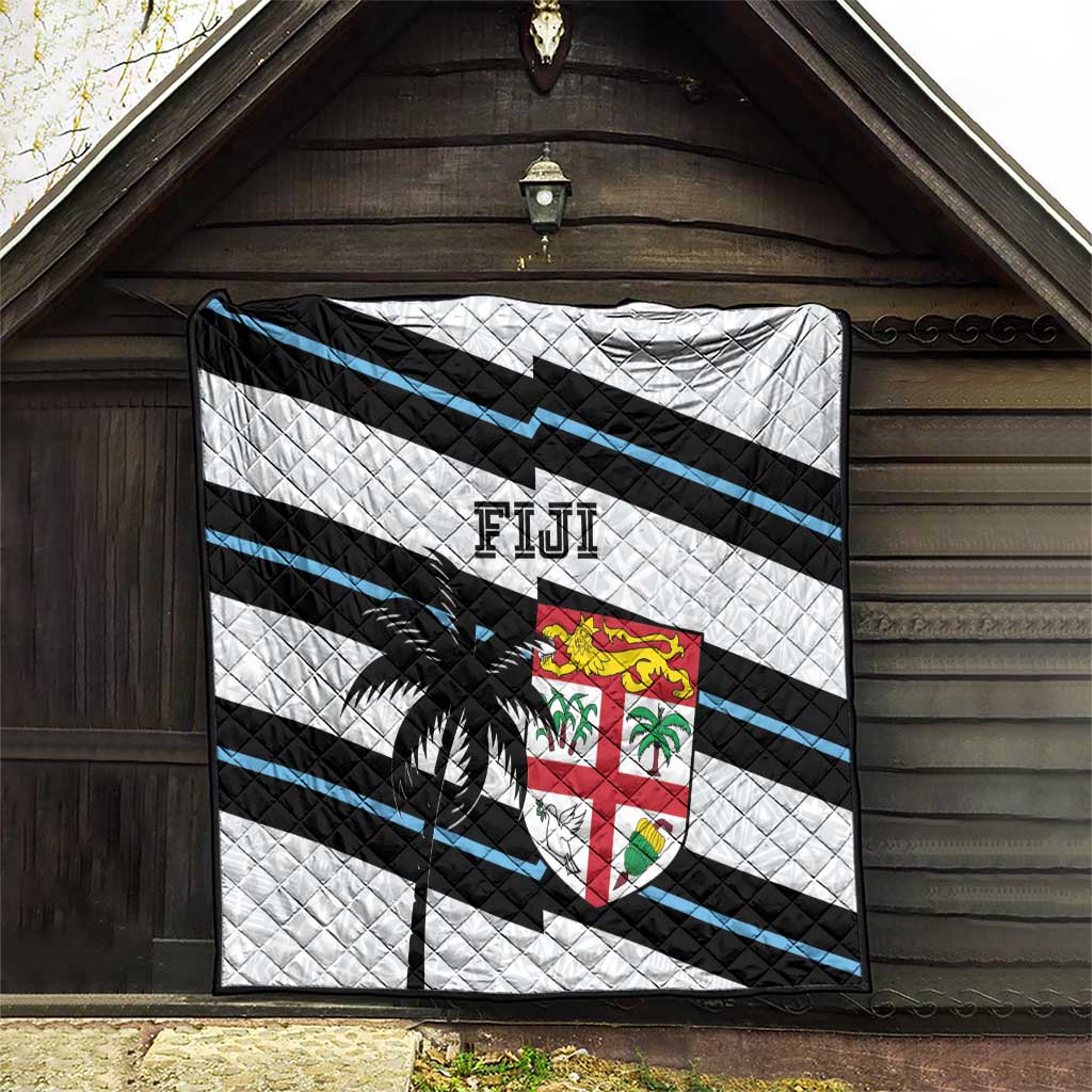Rugby quilt hanging in doorway: white, black and blue stripes with palm tree and Fiji crest