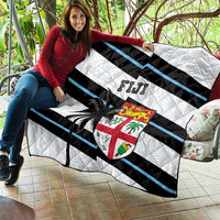 Rugby quilt held outdoors: white base with black and blue stripes, palm tree and Fiji crest