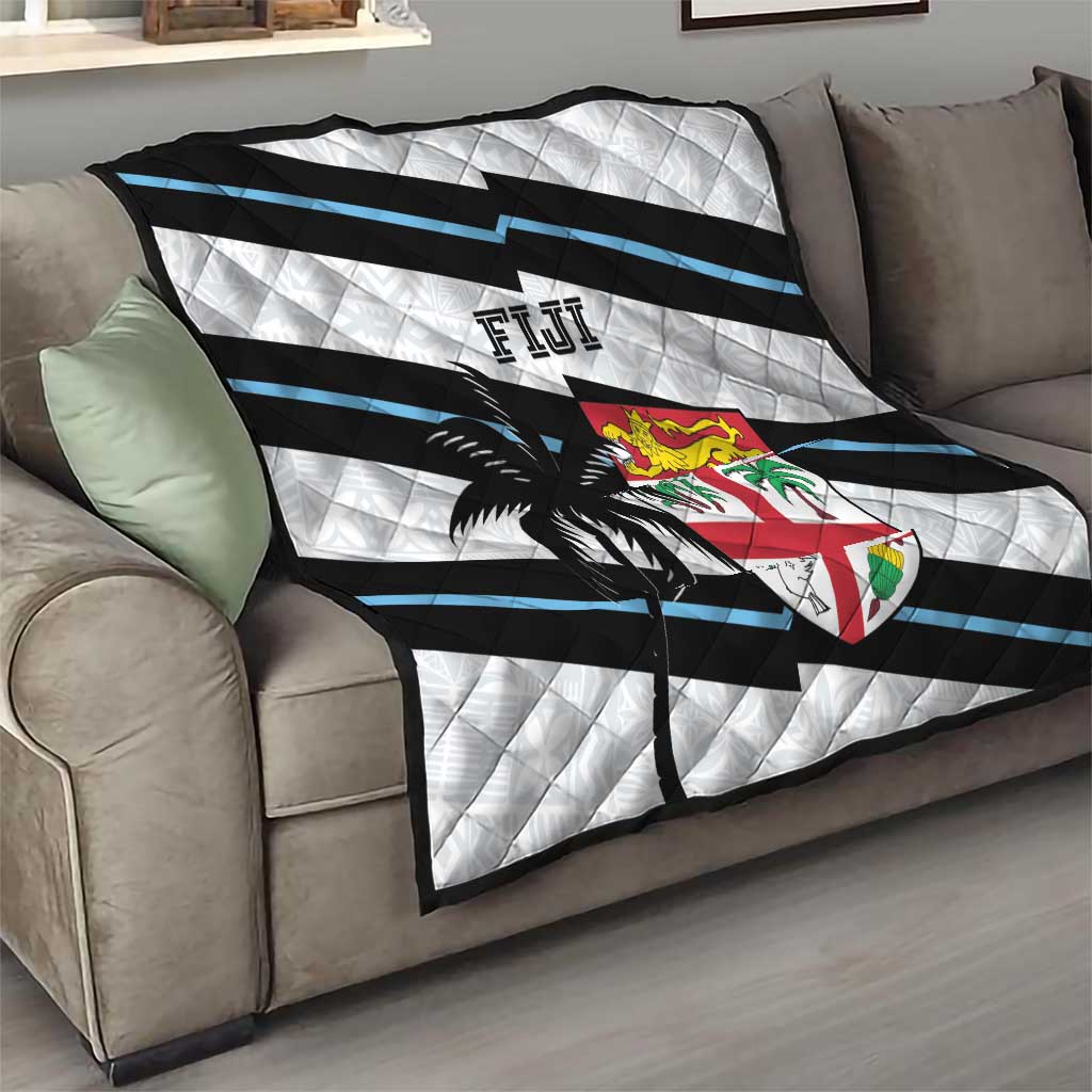 Rugby quilt on sofa: white quilted fabric with black and blue stripes, palm tree and Fiji crest