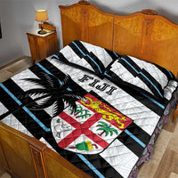 Fiji quilt bed set with matching pillows; quilted white, black and blue pattern with crest