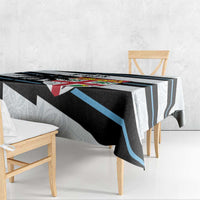 White rugby tablecloth draped on table, black and blue stripe panel with tapa motifs