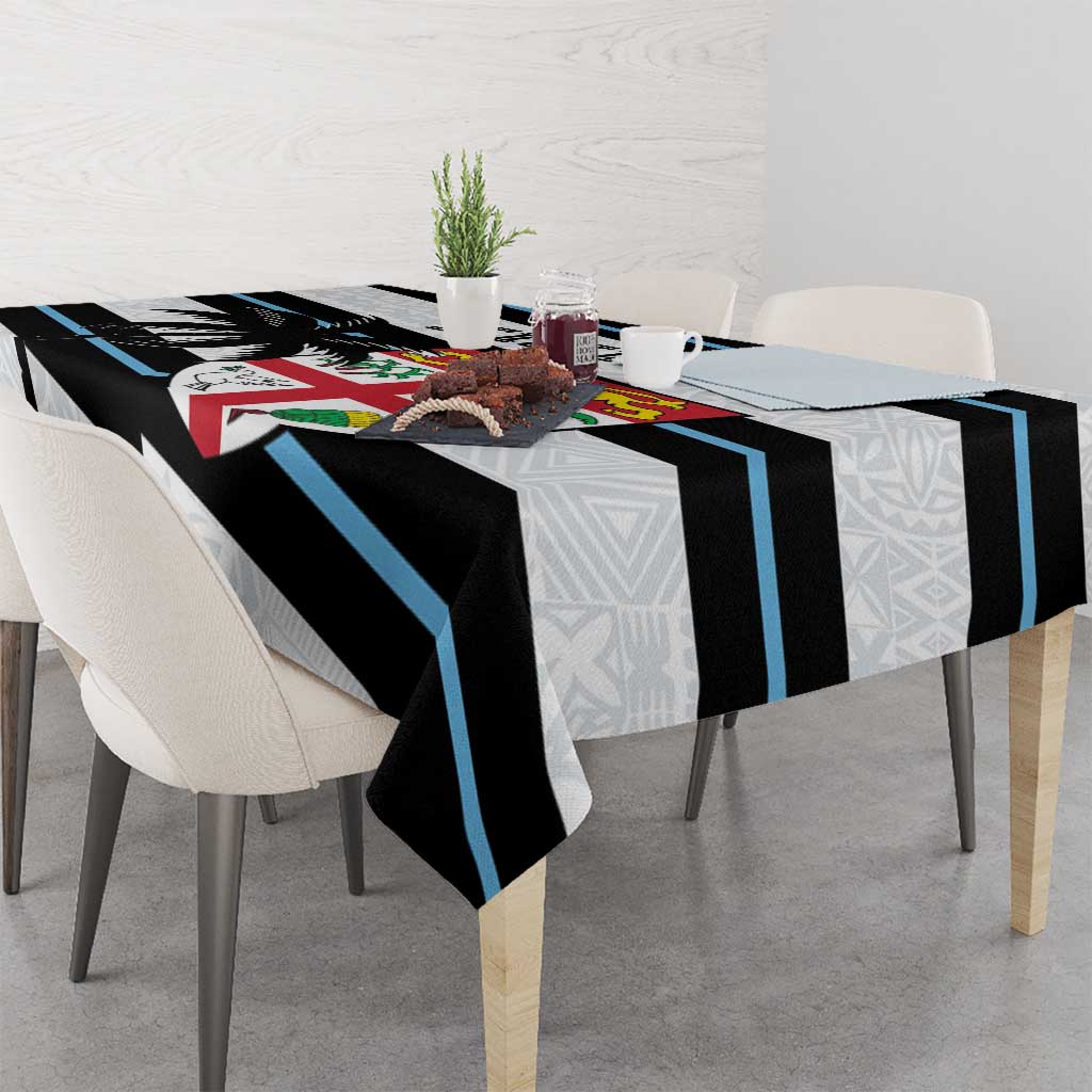 White rugby tablecloth on dining table with black and blue stripes and tapa geometric border