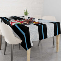 White rugby tablecloth on dining table with black and blue stripes and tapa geometric border