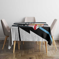 White rugby tablecloth on dining table, black and blue stripes with Fiji emblem panel