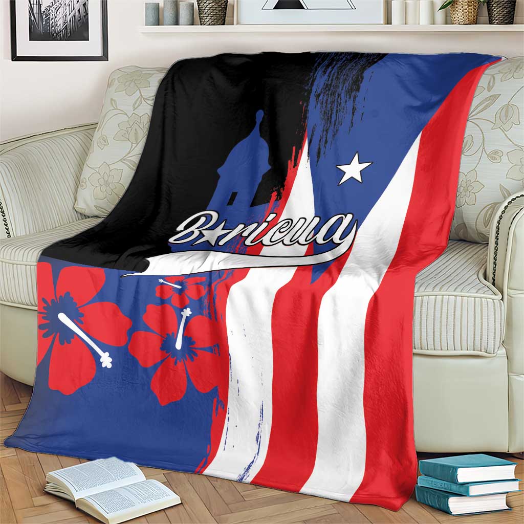 Puerto Rico flag-style fleece blanket draped on couch with Boricua logo and El Morro silhouette