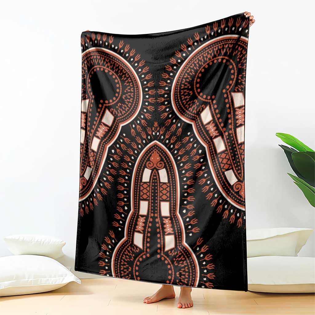 Black blanket with large central dashiki motifs, draped over chair