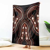 Black blanket with large central dashiki motifs, draped over chair