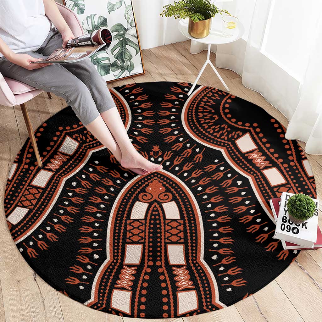 Round black area rug with orange and cream geometric arch medallion pattern, tribal border