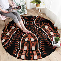 Round black area rug with orange and cream geometric arch medallion pattern, tribal border