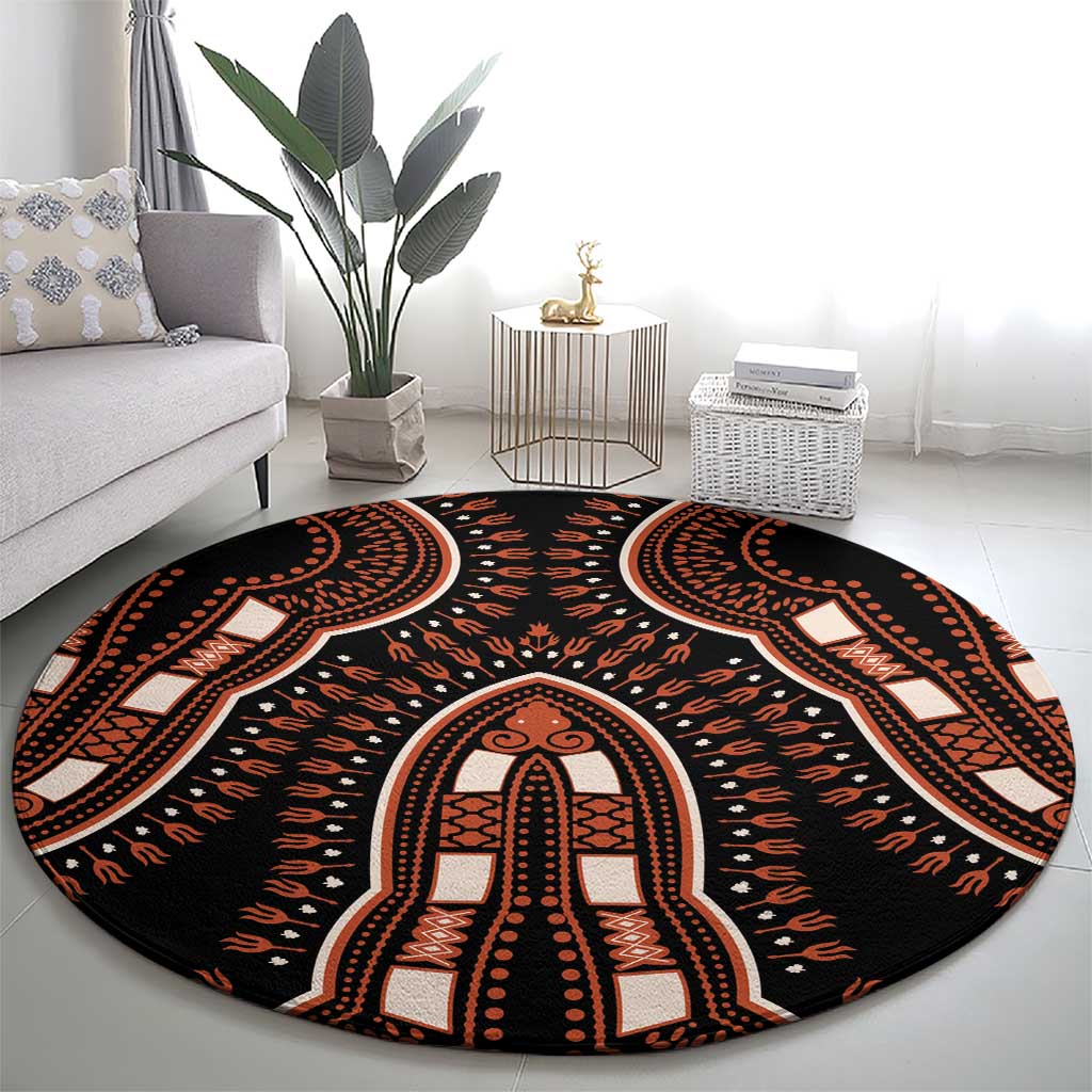 Round black area rug with large central medallion and orange dotted tribal pattern