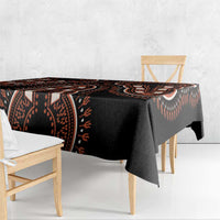 Black dashiki tablecloth with orange geometric banding, corner fabric drop