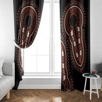 Black dashiki patterned window curtain panels framing a bright window opening.