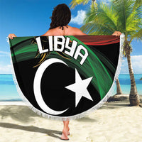 Round beach blanket with Libya flag star & crescent, white fringe edge in hand