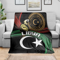 Black flag-themed blanket with white crescent and star and circular emblem on sofa