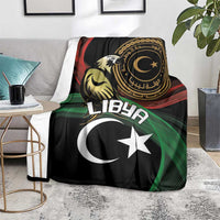 Black flag-themed blanket over chair with white crescent and star, green red stripes