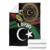 Black flag-themed blanket with white crescent and star, shown with folded white towels