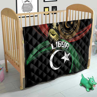 Black quilted blanket in baby crib with Libya crescent-and-star emblem