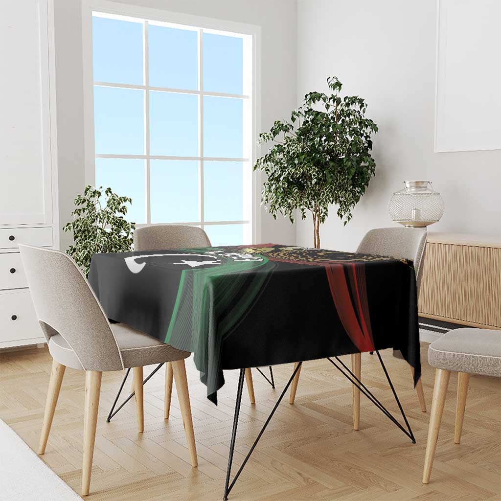 Black tablecloth with Libya crescent-and-star print, green/red diagonal accents on dining table