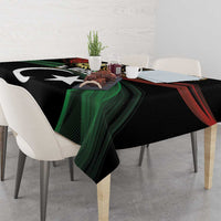 Black tablecloth with large white crescent and star motif, green and red wave stripes