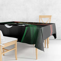 Black tablecloth with white star and crescent emblem, green-red swirls on table edge